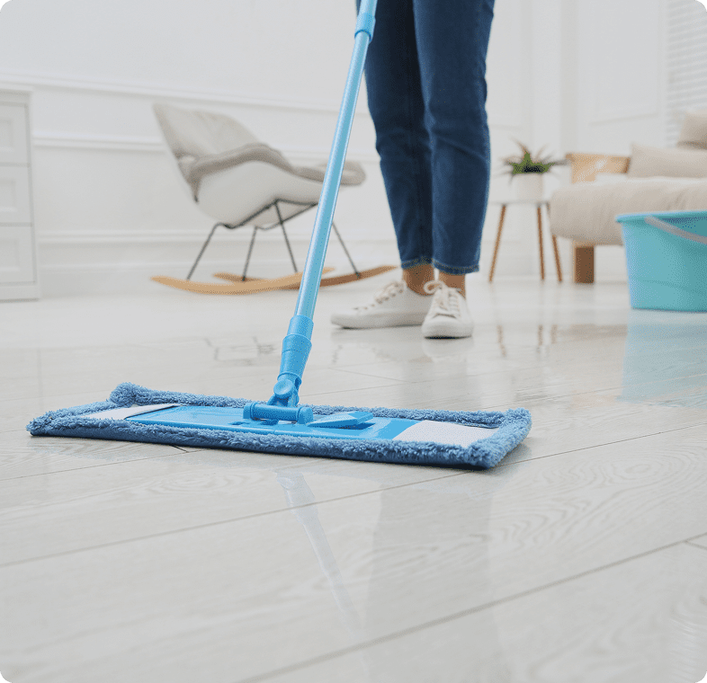 Person mopping wooden floor